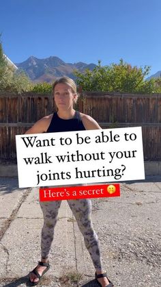 a woman holding up a sign that says, want to be able to walk without your johns