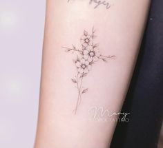 a woman's arm with flowers on it and the words happy written in cursive writing