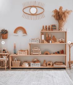 a living room filled with lots of furniture and decor on top of a wooden shelf