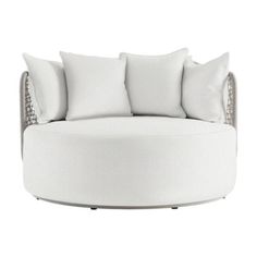 a white round couch with pillows on the top and bottom, in front of a white background