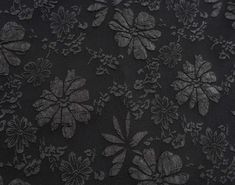 an image of black fabric with flowers on it