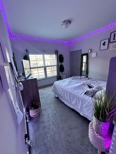 a bed room with a neatly made bed and purple lighting