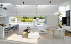 a living room filled with furniture and a flat screen tv on top of a wooden floor