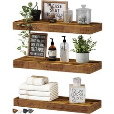 three wooden shelves with towels, soaps and other bathroom items on top of them