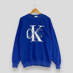 "REMINDER: THIS IS USED CLOTHING PLEASE DO NOT EXPECTED IT LIKE TO BE NEW OR IN PRISTINE CONDITION Feel free to contact me for any question. I'll assist you with my pleasure. CALVIN KLEIN Crewneck Sweatshirt Medium Vintage 1990's Calvin Klein New York Big Logo Streetwear Calvin Klein Jeans Blue Sweater Size M *All measurements are taken with the garment flat on the ground. SIZE ON TAG :- Size L but fits like Size M ACTUAL SIZE MEASUREMENT :- ARM PIT TO ARM PIT :- 21\" inches BACK COLLAR TO HEM :- 27\" inches CONDITION :- GREAT USED CONDITION. NO HOLES AND STAINS. ** WE ARE USING DHL EXPRESS, IT TAKES 3-5 WORKING DAYS ONLY TO ARRIVE. PLEASE LEAVE YOUR PHONE NUMBER ON THE NOTE WHILE MAKE A PURCHASE** REF : (20-11-2023) R205" Blue Sweater, Used Clothing, Calvin Klein Jeans, Blue Sweaters, Crewneck Sweatshirt, Sweat Shirt, Sweater Sizes, Calvin Klein, Crew Neck Sweatshirt