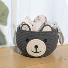 a crocheted basket with stuffed animals in it