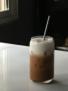 there is a drink on the table with a straw in it's glass cup