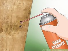 a hand holding a spray bottle and spraying it on a wooden surface with the words card cleaner