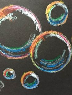 a chalk drawing of three circles with colored crayons