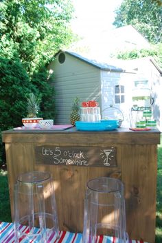 an outdoor bar with three wine glasses on it