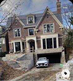 a car parked in front of a house under construction