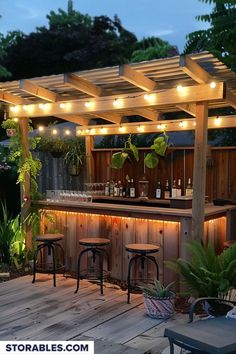 an outdoor bar is lit up with lights