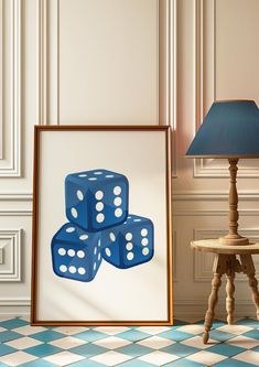 two blue dices sitting on top of each other in front of a framed photo