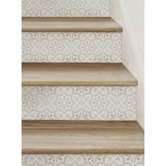 some stairs with white and beige wallpaper on them