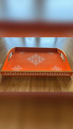 an orange tray sitting on top of a wooden table