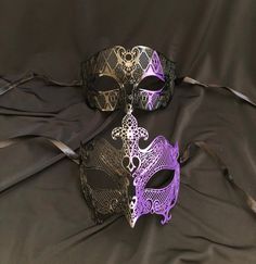 This couple's masquerade masks are great for any Venetian mask party or masquerade ball. The women's mask is made of a lightweight metal and is hand painted in a two-tone purple and black . The men's mask is also made of a lightweight metal and hand painted with purple color diamond.  Both masks have some flex and come with black silk ribbon ties attached. Women's mask size 6"W x 5"H. Men's mask size 7"W x 4.25"H. Color of masks aqua and black. Adjustable Black Fantasy Mask, Adjustable Black Masks And Prosthetics For Carnival, Adjustable Black Fantasy Masquerade Mask, Gothic Adjustable Masquerade Mask, Adjustable Black Masquerade Mask For Carnival, Black Adjustable Masquerade Mask For Carnival, Gothic Masquerade Mask For Mardi Gras, Adjustable Black Masks And Prosthetics For Masquerade, Black Adjustable Mask For Masquerade