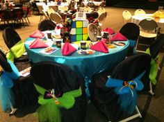 the tables are set up for a party with colorful decorations and decor items on them