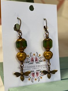 Welcome to our listing. These are a one of a kind pair of earrings using the best materials. The beads are beautiful Czech beads and the charm is a beautiful antique natural brass bee charm.  These are a unique pair of earrings that cannot be duplicated so you will have a unique piece of wearable art.  Please reach out with any questions.  Thanks for stopping by. Gift Brass Beaded Earrings With Round Beads, Bronze Dangling Beads Earrings For Gift, Bronze Earrings With Dangling Beads For Gift, Adjustable Bronze Beaded Earrings As Gift, Gift Bronze Beaded Earrings, Antique Earrings With Vintage Charm For Gift, Antique Earrings With Vintage Charm As Gift, Vintage Gold Beaded Earrings With Dangling Beads, Antique Vintage Charm Earrings For Gift