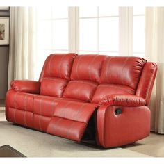 a red leather reclining sofa in a living room