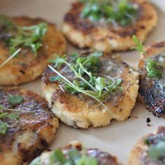 some food is sitting on a plate with green garnish and sprigs