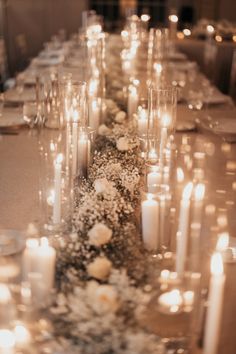 a long table with candles and flowers on it