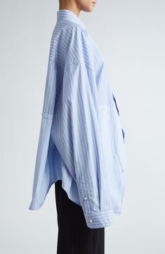 Iconically oversized, this striped button-up shirt boasts boldly dropped shoulders and an asymmetric collar. 32 1/2" front length; 30 1/2" back length (size 8US/38FR) Front button closure Asymmetric point collar Long sleeves with button cuffs Dropped shoulders 100% cotton Dry clean or machine wash, line dry Made in Italy Designer Clothing Balenciaga Shirt, Blue And White Striped Shirt, Designer Clothing Brands, Cut Up, Asymmetrical Tops, Fabric Store, Fashion Details, Striped Shirt, Sleeve Cotton