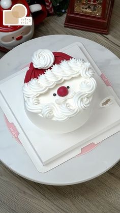 there is a cake that looks like santa claus on the plate and it has been decorated with icing