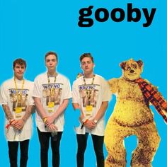 three men standing next to each other in front of a blue background with the words gooby on it