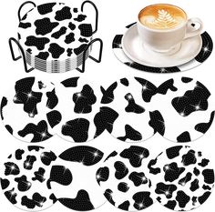 coffee cup, saucer and coasters with black and white designs on them in the shape of hearts