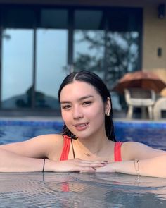 a woman in a swimming pool posing for the camera