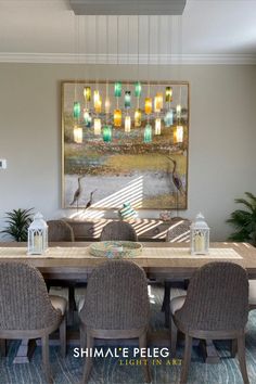 a dining room table with chairs and a painting on the wall above it that says shimale peeg