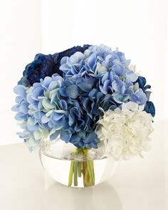 a bouquet of blue and white flowers in a vase