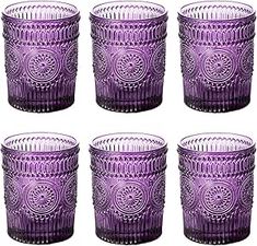 six purple glass tumblers sitting next to each other