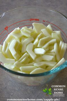 chopped apples in a glass bowl on a counter