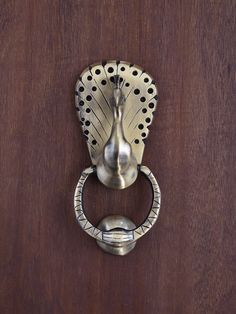 a metal door handle on a wooden door with holes in the front and back part