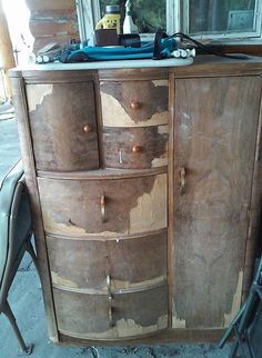 an old wooden cabinet is being painted brown