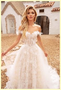 a woman in a white wedding dress posing for the camera with her hand on her hip