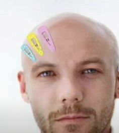 a man with different colored hair clips on his head