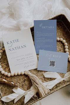 the wedding stationery is laid out in a wicker basket with beads and tassels