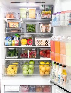 an open refrigerator filled with lots of fresh fruits and veggies in plastic containers