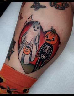 a couple of pumpkins and ghost tattoos on the arm