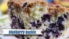 a close up of a piece of cake on a plate with the words blueberry bucklee above it