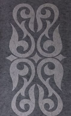 a black and white image of an intricate design on a gray shirt that is worn by someone