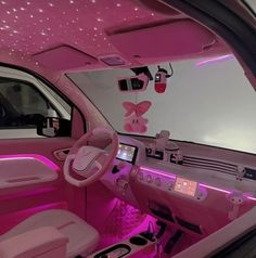 the interior of a car with pink lights and decorations on the walls, including butterflies