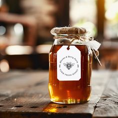 a jar of honey sitting on top of a wooden table