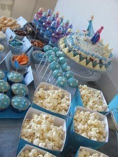 a table filled with blue and white desserts