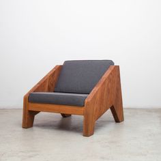 a wooden chair sitting on top of a cement floor