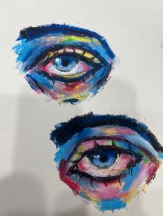 two different colored eyes are shown in this drawing technique, one is drawn on paper and the other is painted with acrylic paint