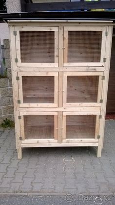 a cabinet made out of wooden pallets with wire doors on the top and bottom