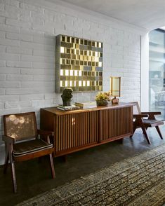 a white brick wall and wooden furniture in a room